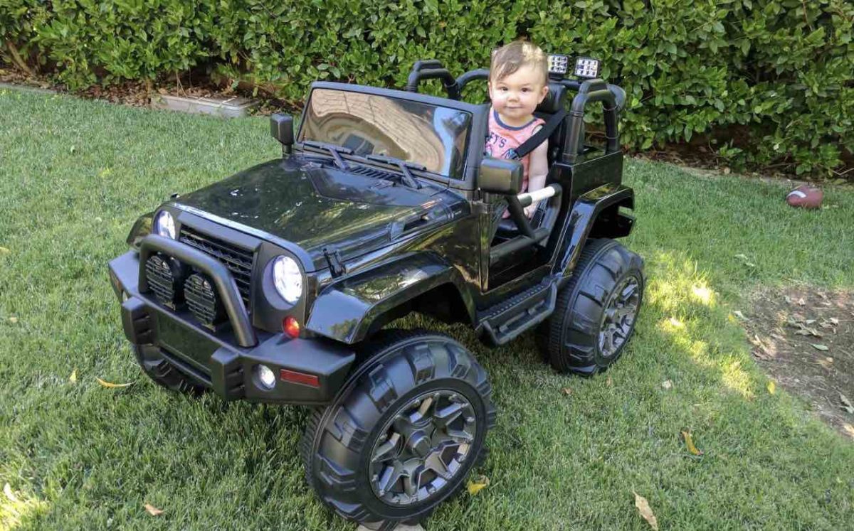 Image of a child in a jeep style kids electric ride on car